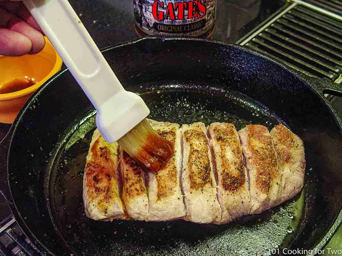 brushing BBQ sauce on boneless ribs after searing