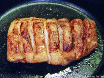 cooked bbq boneless pork ribs in black skillet.