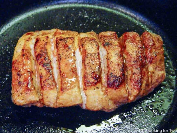 cooked bbq boneless pork ribs in black skillet.