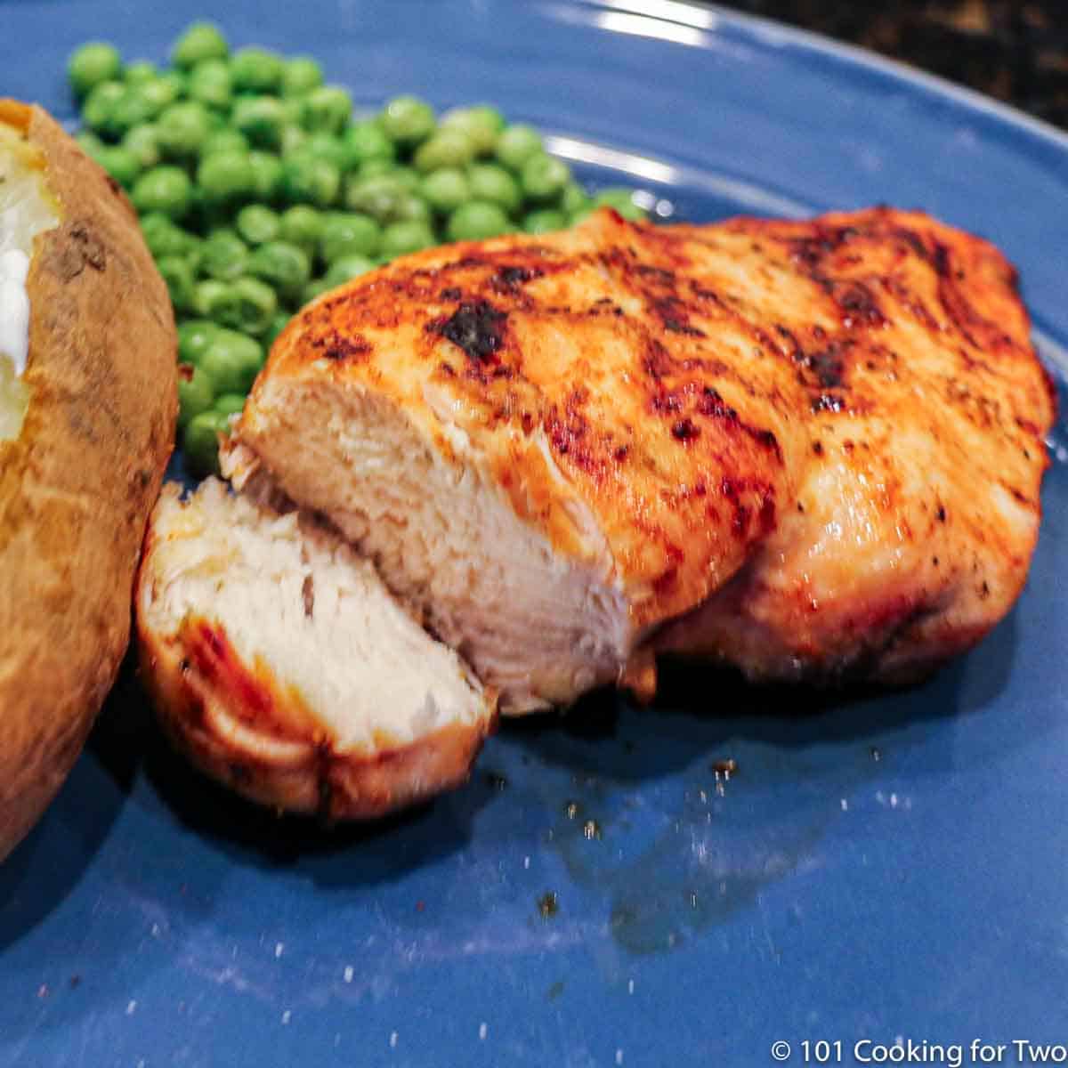 cut chicken breast on a blue plate.
