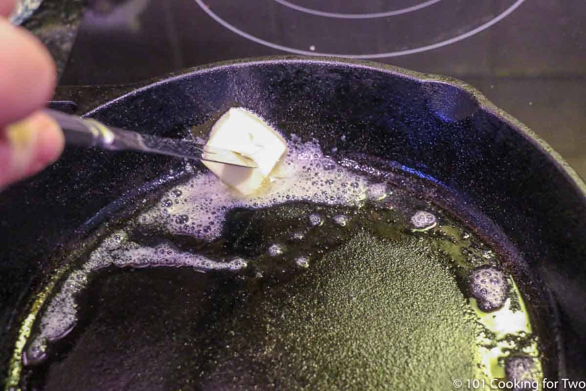 melting butter in preheated skillet