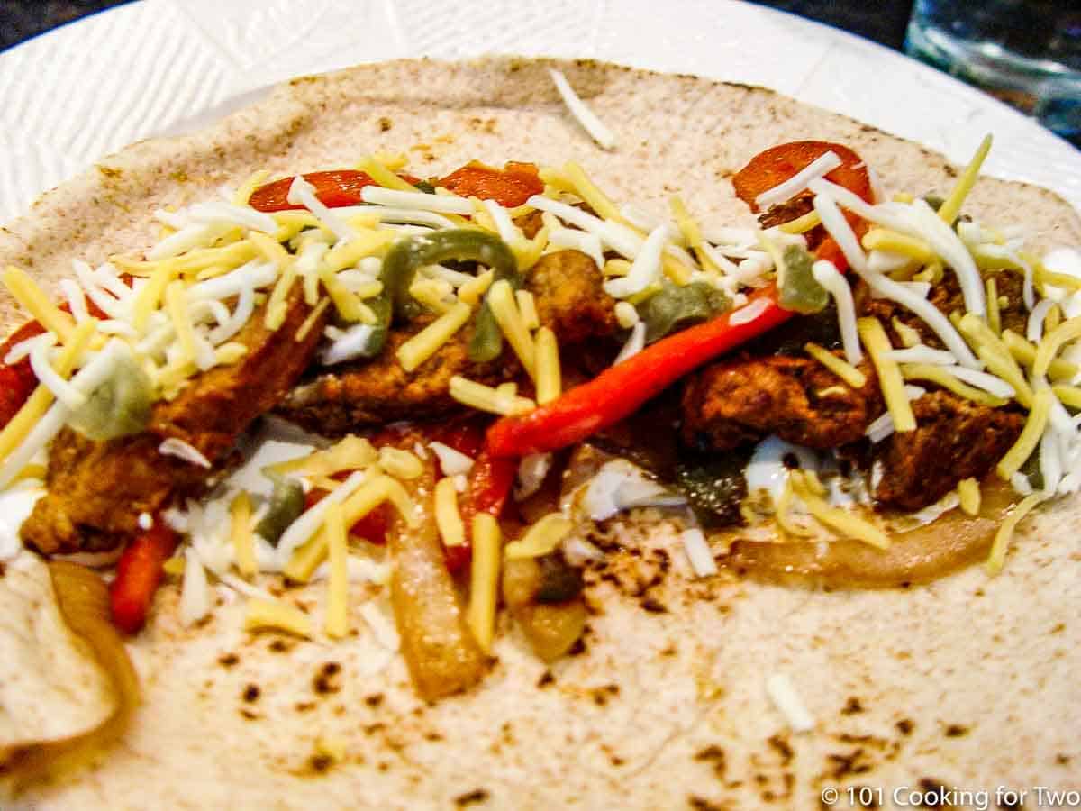 pork fajita on a white plate.