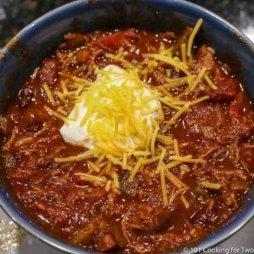 shredded beef chili in a blue bowl