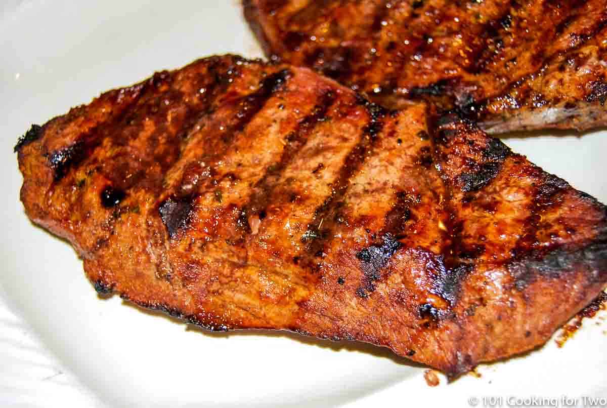 sirloin steaks on a white plate.