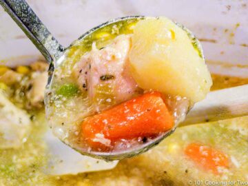 wide view of chicken stew on a ladle