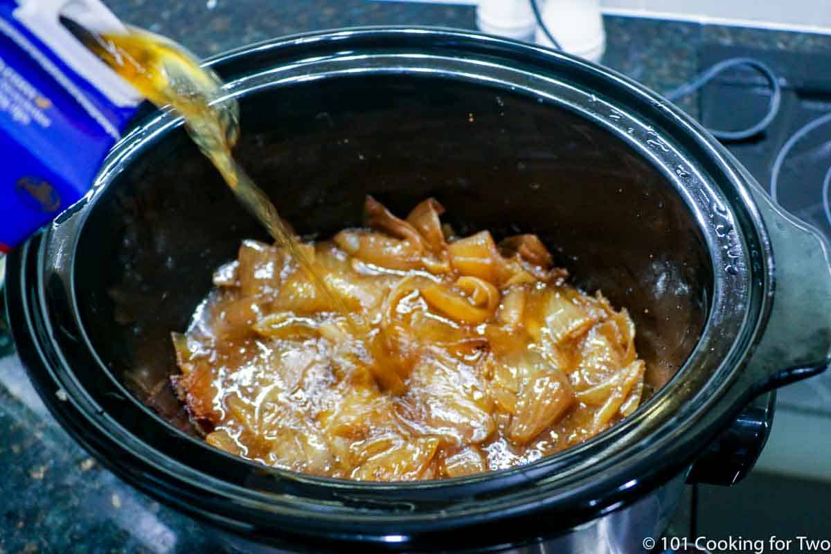 adding broth to cooked onions.