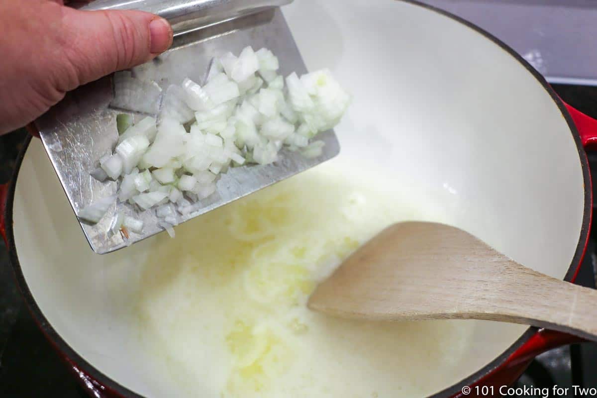 adding chopped onion to melted butter.