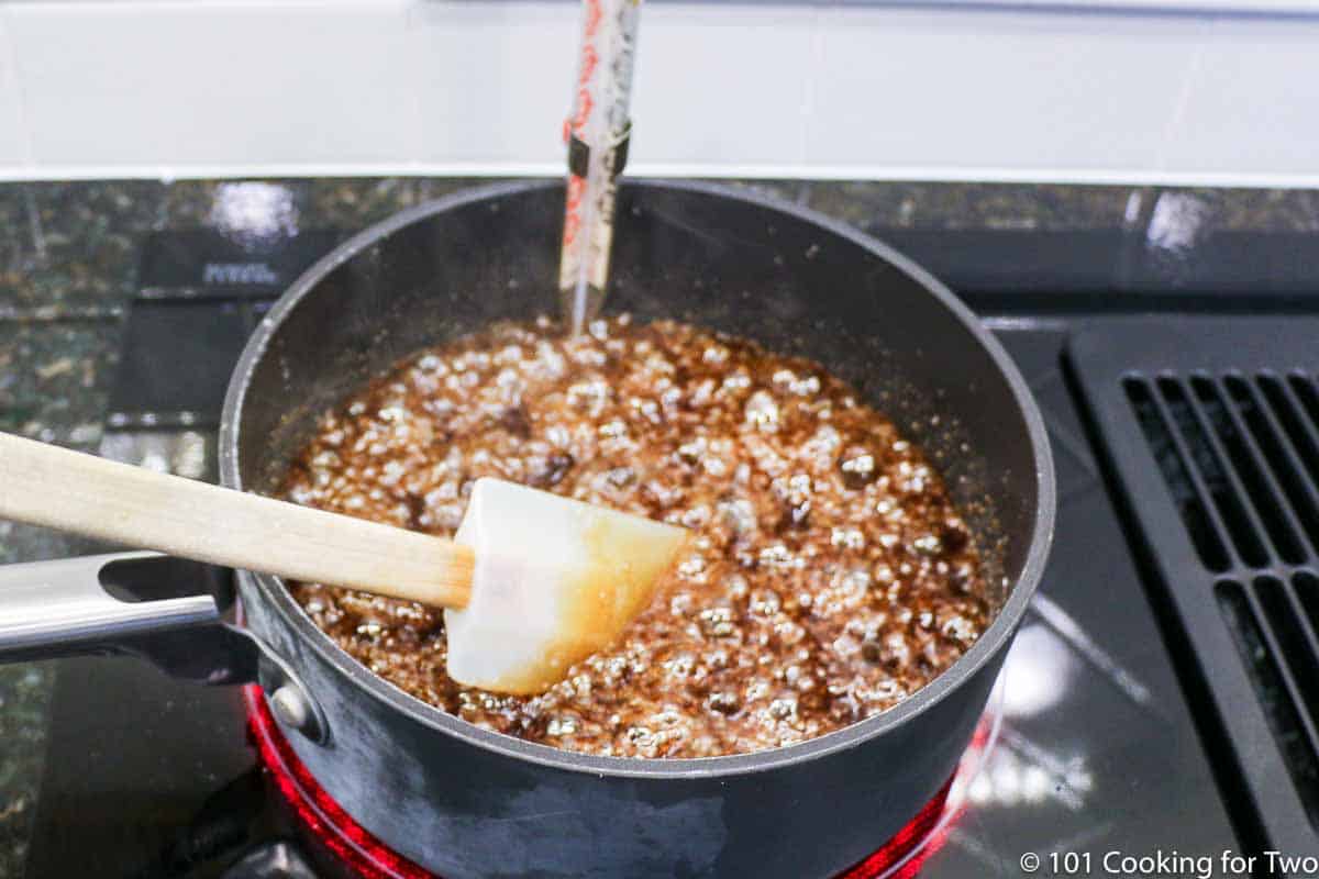 boiling caramel in pan with candy thermometer