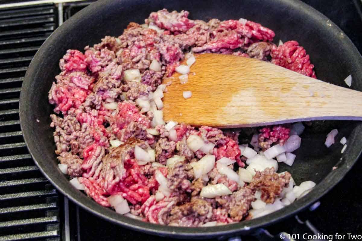 browning burger with pepper and onion.