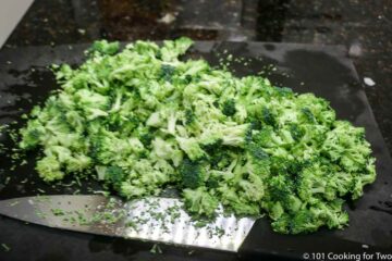 chopped broccoli on black board