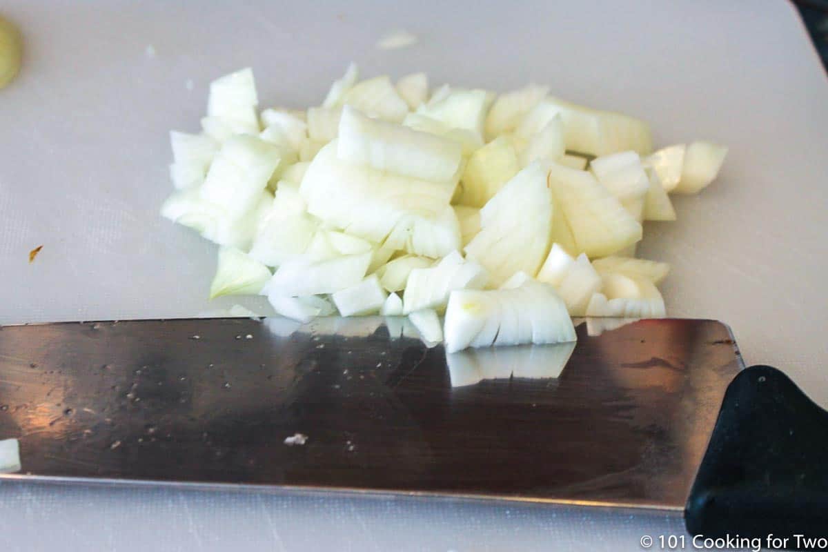chopped onion on white board.
