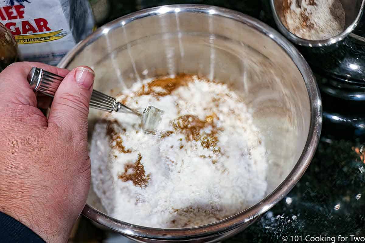 mixing dry ingredients in a metal bowl.