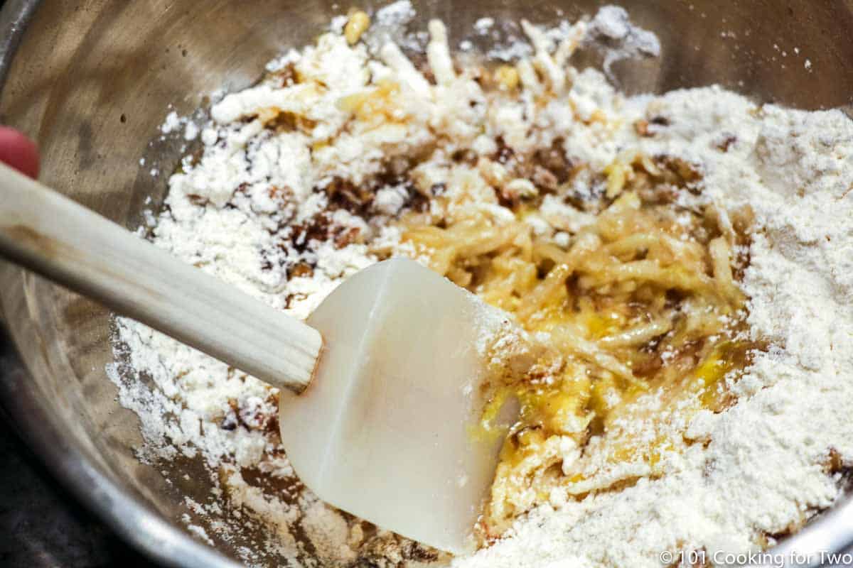 mixing ingredients in a netal bowl.