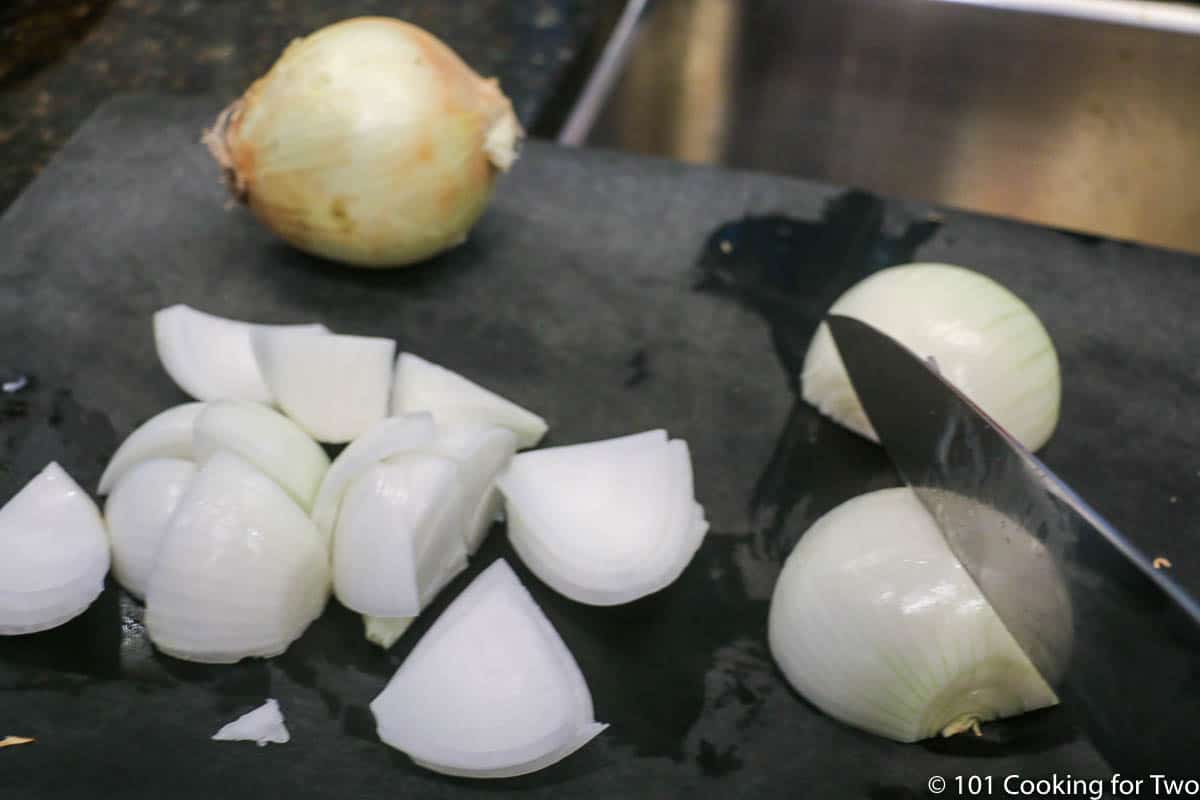 slicing onions on black board.