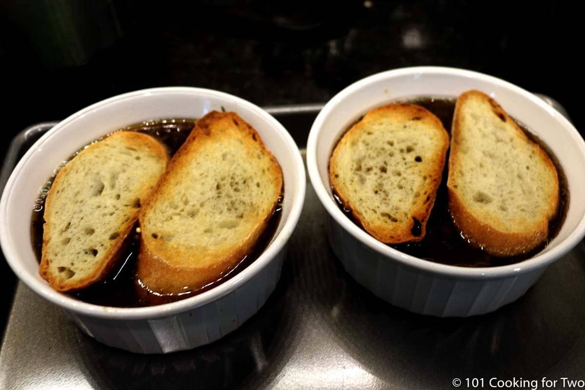 toasted bread on bowls of soup
