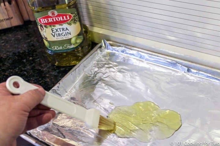 brushing oil on foil covered tray