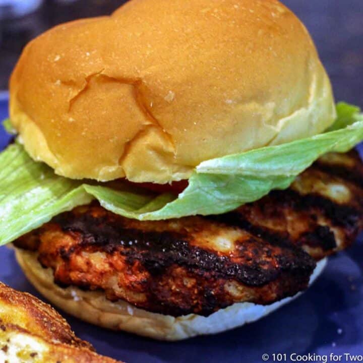 chicken burger on a bun and blue plate