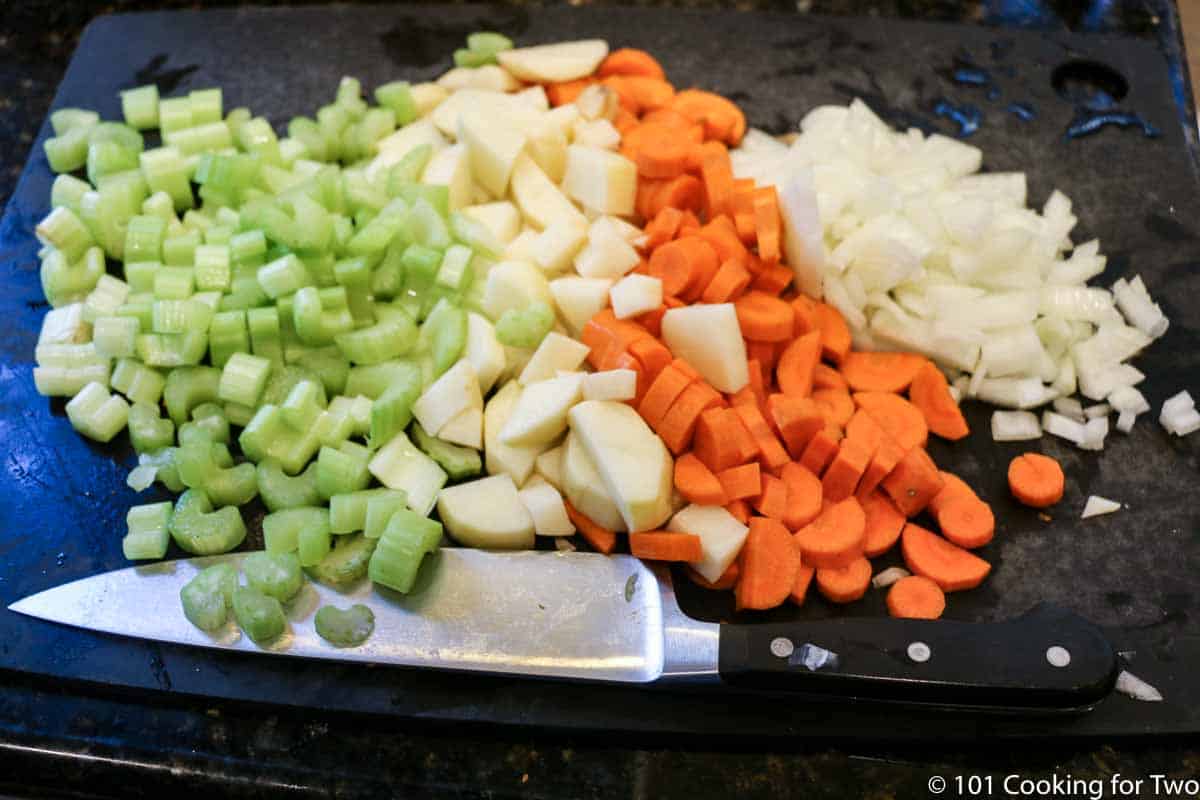 chopped vegetables on a black board.