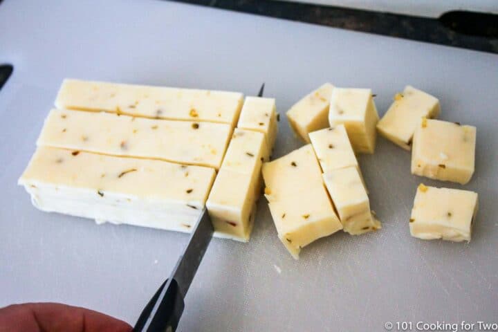 chopping pepper jack cheese into cubes