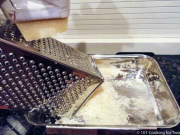 grating fresh Parmesan cheese