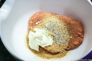 ground chicken with mayo and breadcrumbs in a white bowl