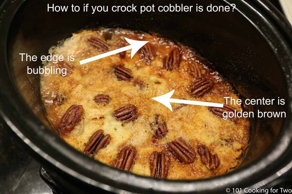 Labeled image of bubbling edge and golden brown top of crock pot cobbler