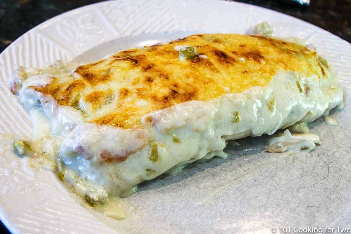 Sour cream chicken enchilida casserole on a white plate