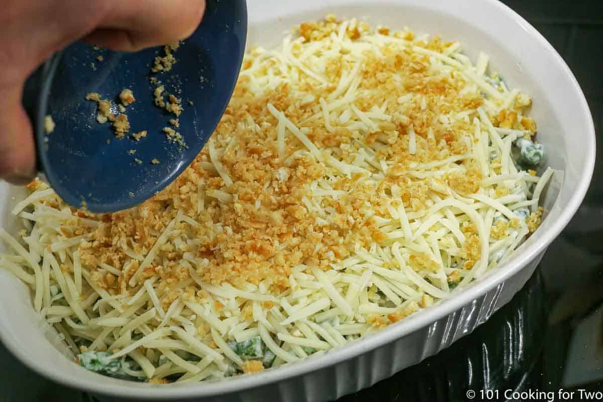 adding ritz topping to casserole.