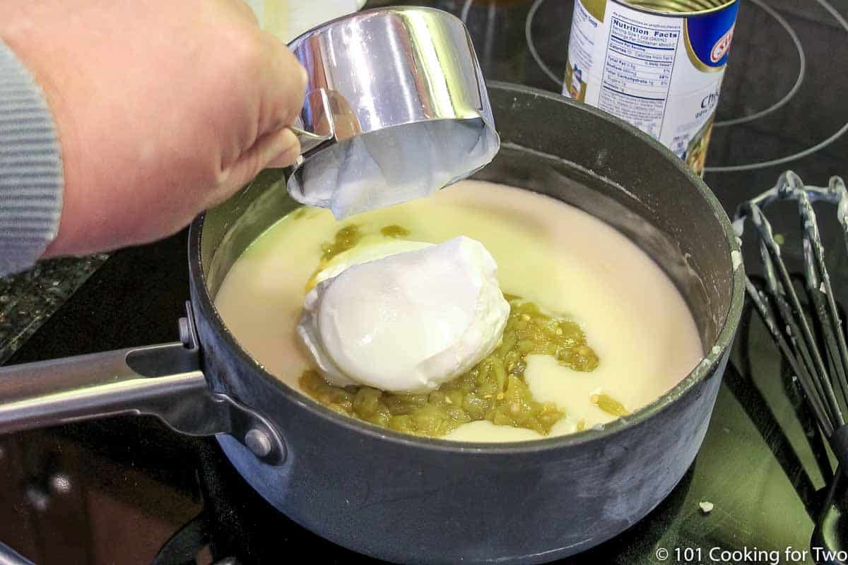 adding sour cream to sauce