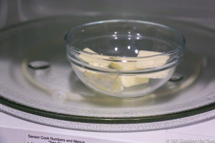 butter in a small glass bowl in a microwave