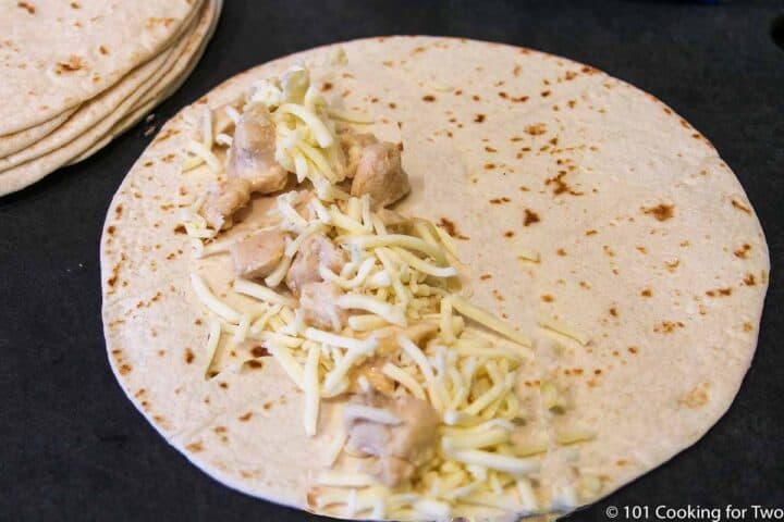 chicken and cheese on the tortilla to the side