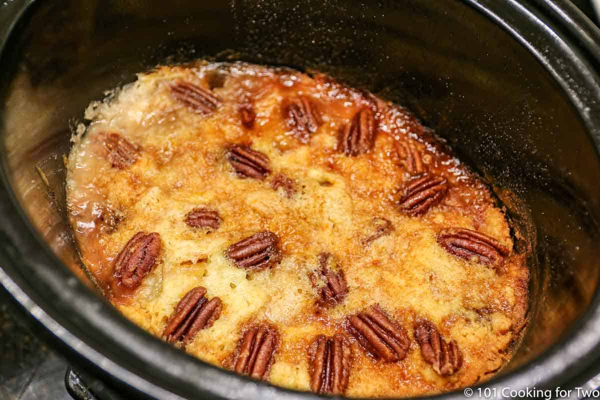 cobbler in the crock pot with golden center and boiling edge.
