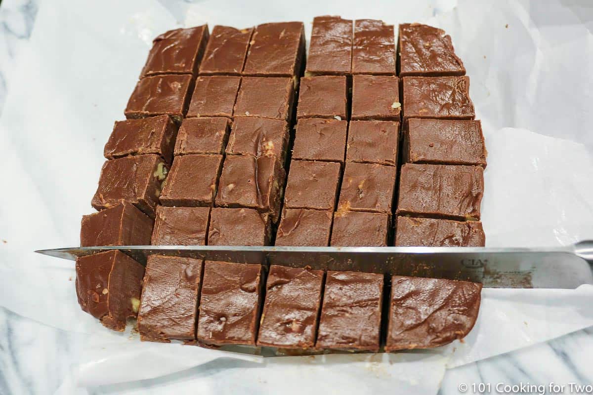 cutting fudge on parchment paper.