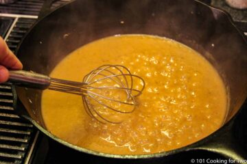 mixing boiling gravy with whisk