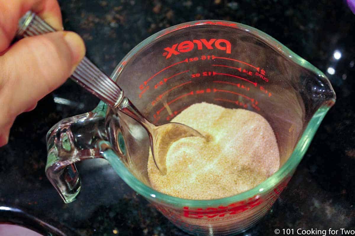 mixing sugar and cinnamon in a mixing bowl.
