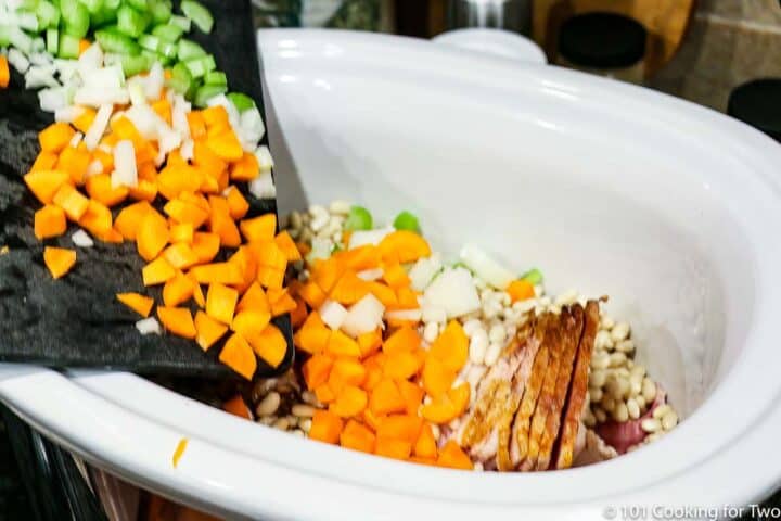 pouring vegetables into crock pot