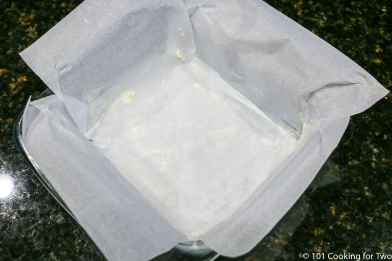preparing a pan with crossed parchment paper