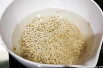 soaking beans in water in white bowl