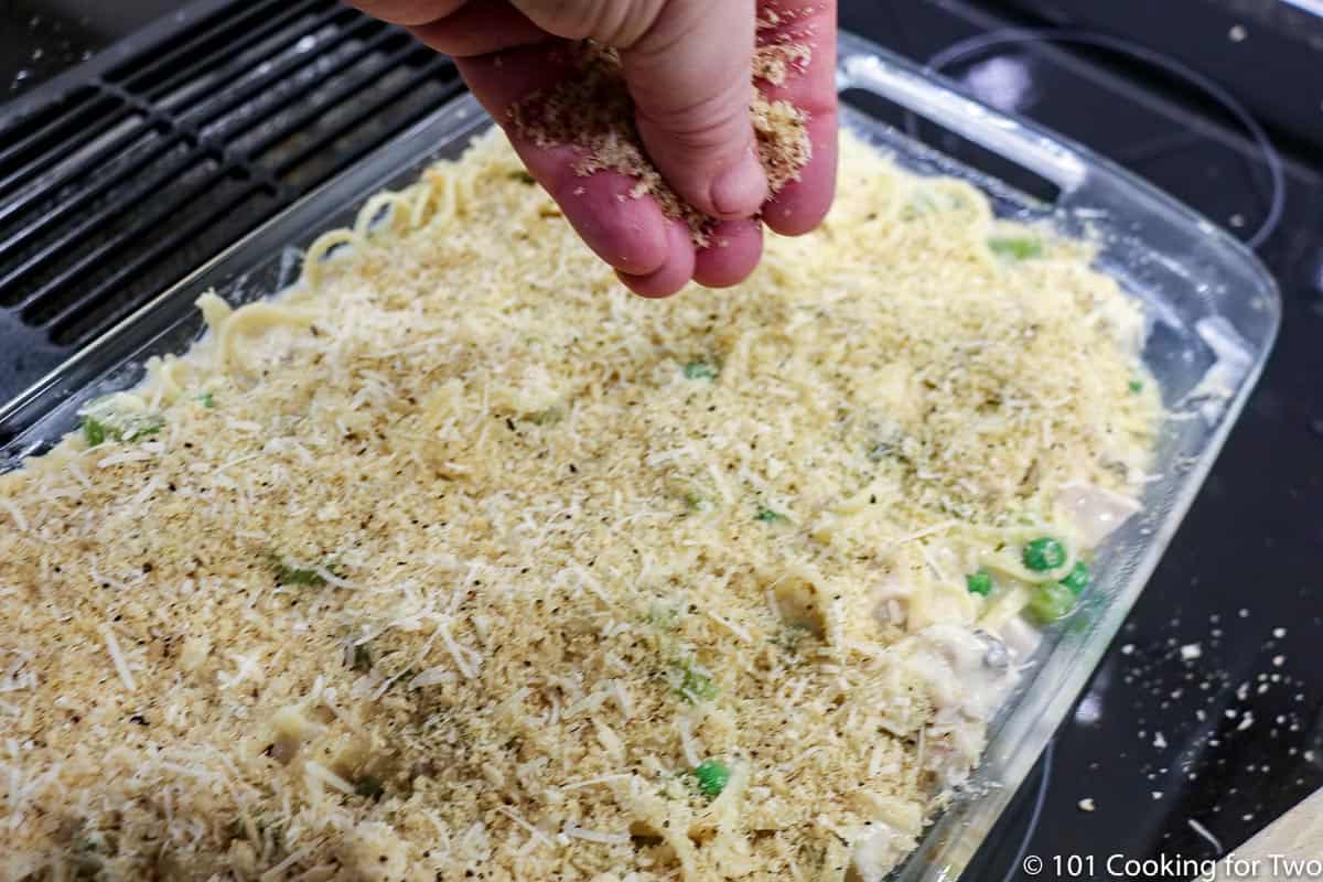 sprinkling cheese and bread crumbs over the casserole.