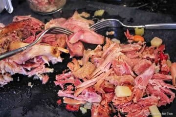 Shredding ham off the bone.