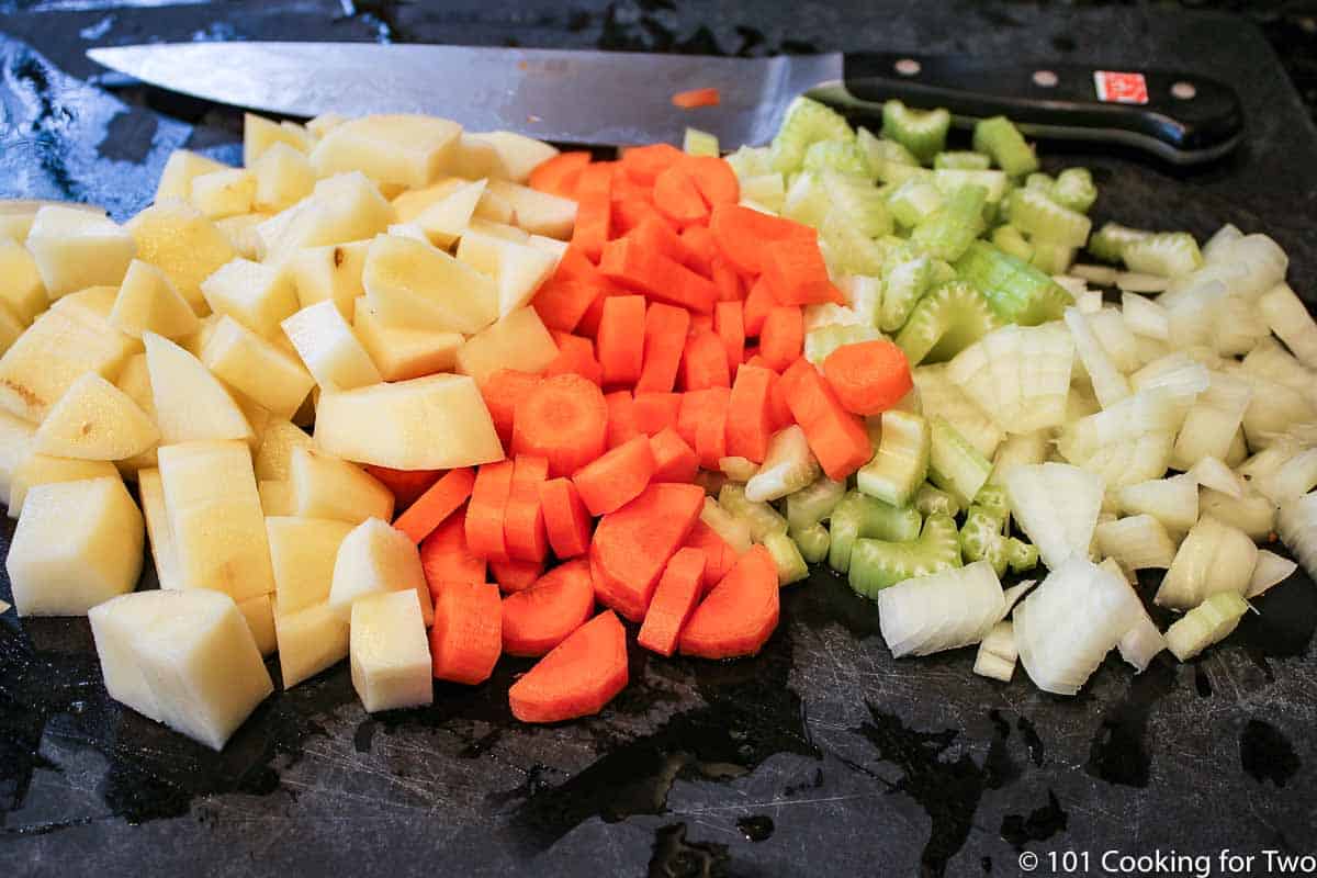chopped soup vegetables on a black board