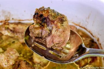 cooked carnita on a large spoon