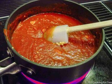 enchilada sauce cooking in a black pan