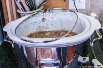 large crock pot with lid set with some opening