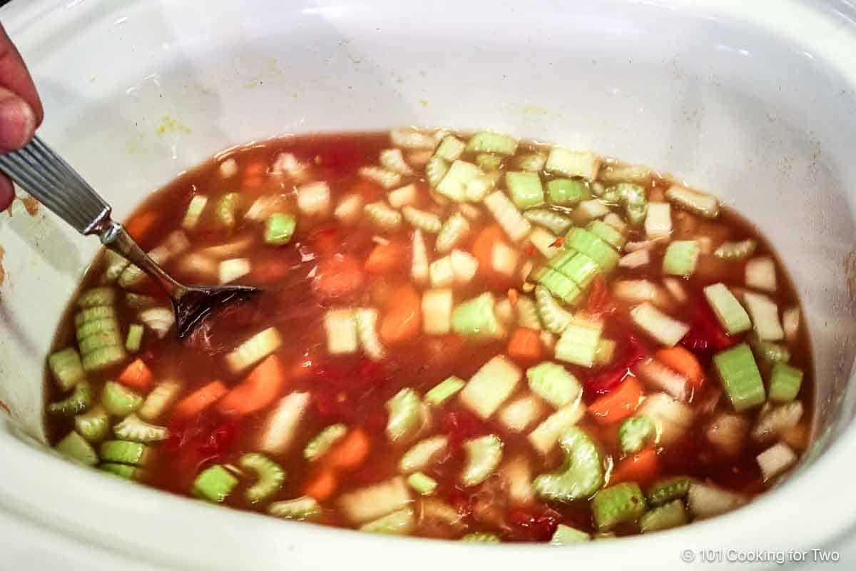Mixing ingredients in the crock pot.