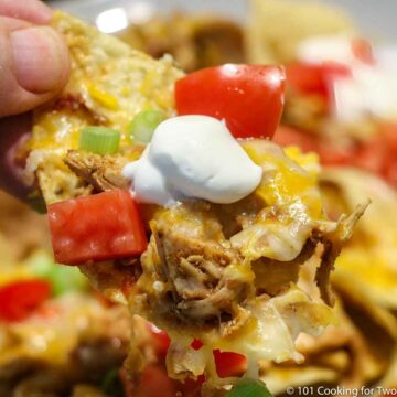nacho chip with chicken taco meat and sour cream