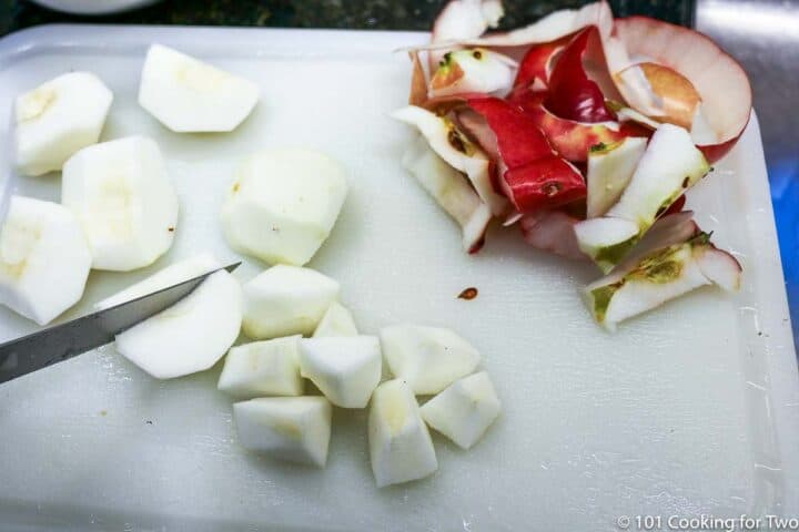 pealed apples being cut up on white board