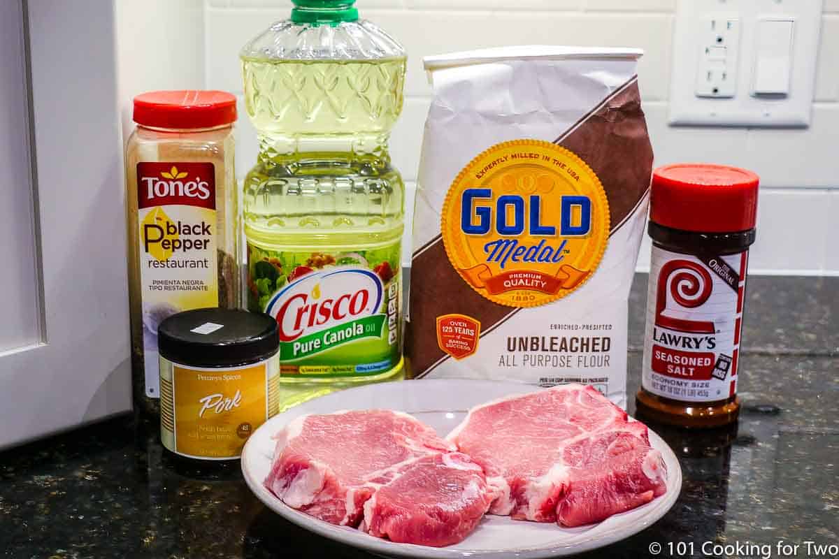 pork chops with seasoning and gravy ingredients.