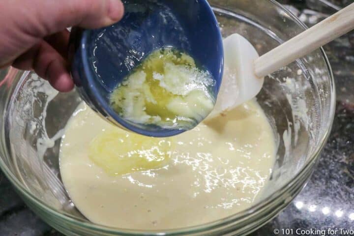 pouring melted butter into batter