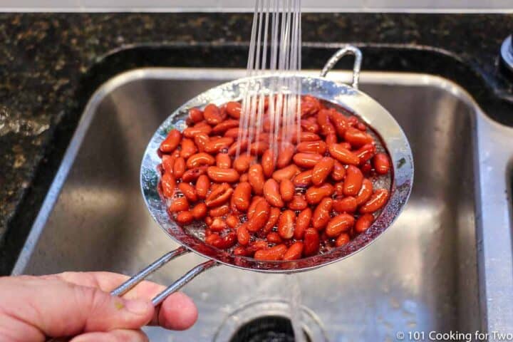 rinsing beans under running water